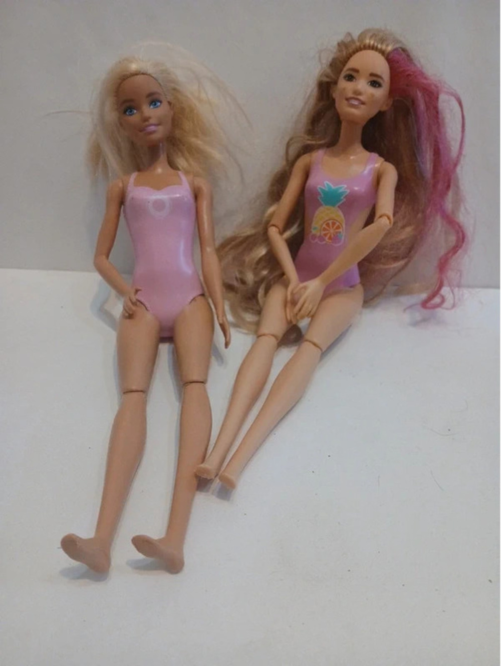 Two barbie dolls